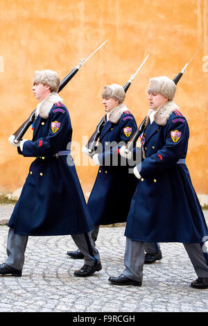 Three guards marching past wall whilst changing at Prague Castle, Czech Republic.