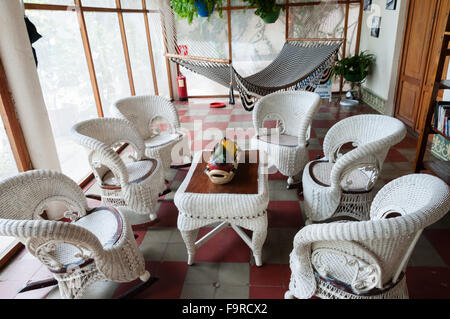 Rattan furniture chair and table with hammock in a room Stock Photo