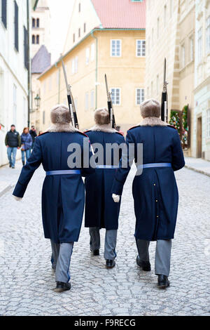 Three guards marching past wall whilst changing at Prague Castle, Czech Republic.