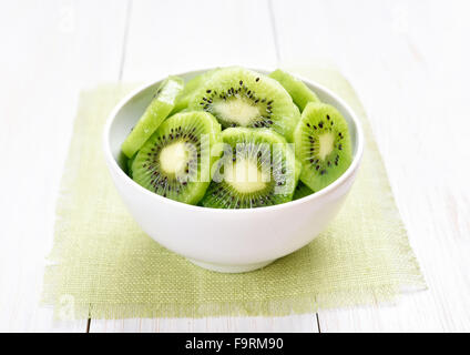 Fruit kiwi slices in white bowl Stock Photo