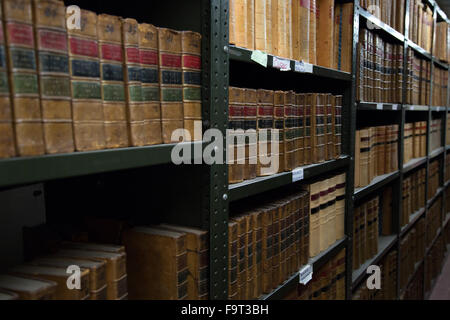 Legal text books and files stored on shelves in a record office Stock Photo