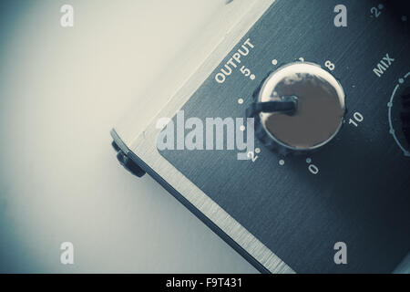 Details of an old guitar pedal, closeup view of output and volume button. Stock Photo