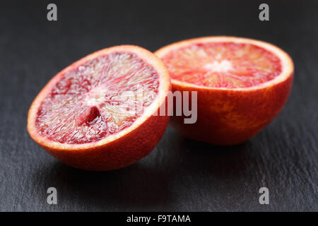 red sicilian oranges sliced on slate board Stock Photo