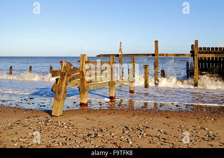 The remains of old wooden sea defences on the beach at Happisburgh, Norfolk, England, United Kingdom. Stock Photo