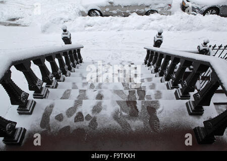 Snow covered Brooklyn brownstone townhouse stoop and sidewalk in winter Stock Photo