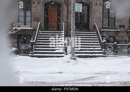 Snow covered Brooklyn brownstone townhouse stoops and sidewalk in winter Stock Photo