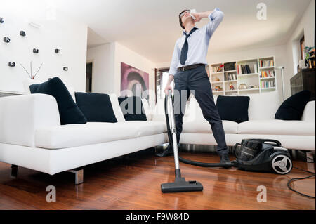 man sweating cleans the floor of the house Stock Photo