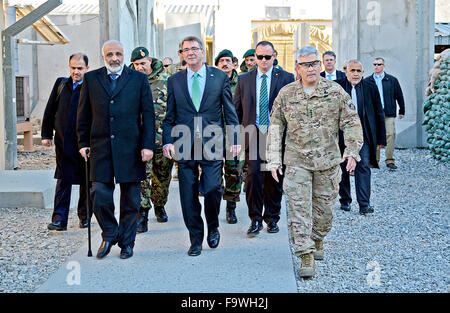 Jalalabad, Afghanistan. 18th Dec, 2015. US Secretary of Defense Ashton Carter and Afghan Defense Minister Mohammed Masoom Stanekzai, left, walk with Commander of U.S. Forces Gen. John Campbell during a surprise visit to Forward Operating Base Fenty December 18, 2015 in Jalalabad, Afghanistan. Stock Photo