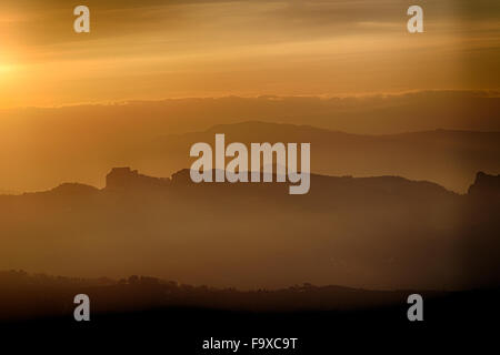 sunset on hilltops in the mist around Titan Mount in the Repubblic of San Marino Stock Photo