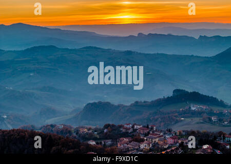 sunset on hilltops in the mist around Titan Mount in the Repubblic of San Marino Stock Photo