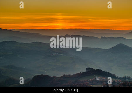 sunset on hilltops in the mist around Titan Mount in the Repubblic of San Marino Stock Photo