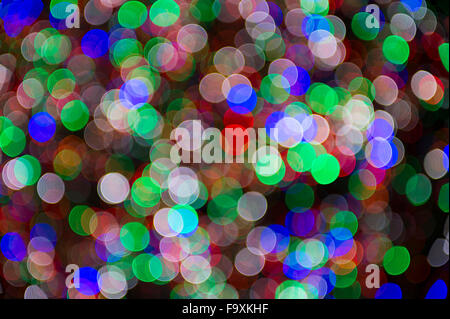 Holiday Christmas tree lights background in bright and colorful bokeh defocus abstract Stock Photo