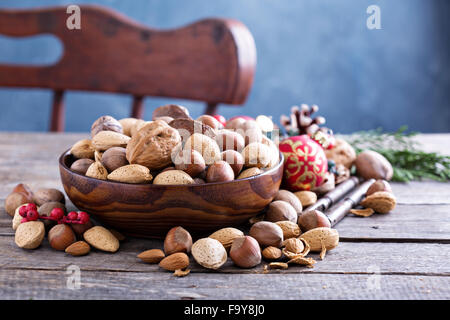 Variety of nuts with shells in a brown bowl Stock Photo
