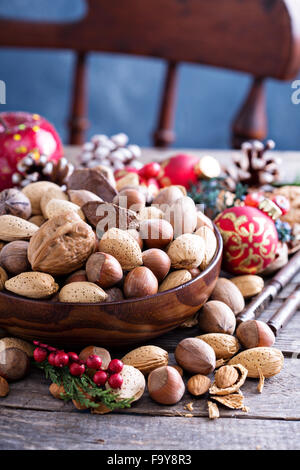 Variety of nuts with shells in a brown bowl Stock Photo