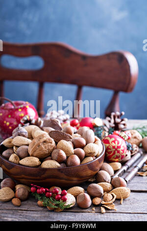 Variety of nuts with shells in a brown bowl Stock Photo