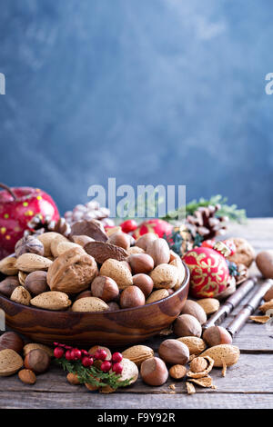 Variety of nuts with shells in a brown bowl Stock Photo