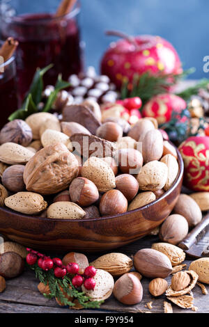 Variety of nuts with shells in a brown bowl Stock Photo