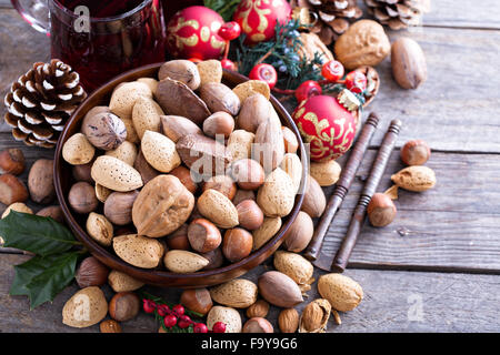 Variety of nuts with shells in a brown bowl Stock Photo