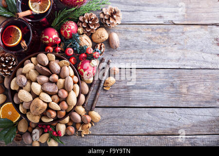 Variety of nuts with shells in a brown bowl Stock Photo