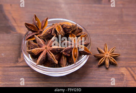 Star anise on bowl on wooden table Stock Photo