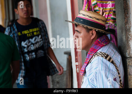 Man Wearing A Native Hat Leaning on a Cemented Pillar Stock Photo