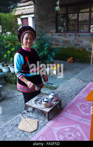 Ethnic Bai lady preparing a special tea,in local everyday costume near ...