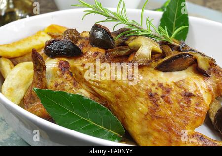 baked chicken with fungus potato and  leaf laurel Stock Photo