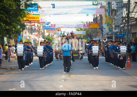 Marching band of young teenagers walking down a downtown street in at the annual Surin Elephant Roundup parade Stock Photo