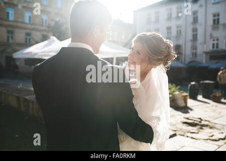 bride and groom posing on the streets Stock Photo