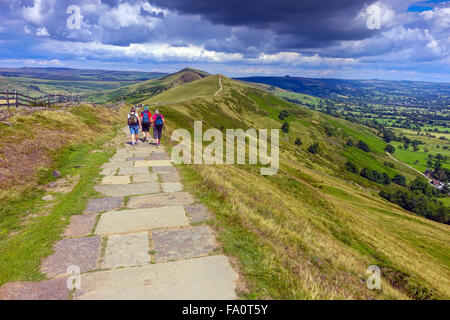 Hikers on the flagged footpath along the Great Ridge above Castleton, Peak District Derbyshire Stock Photo