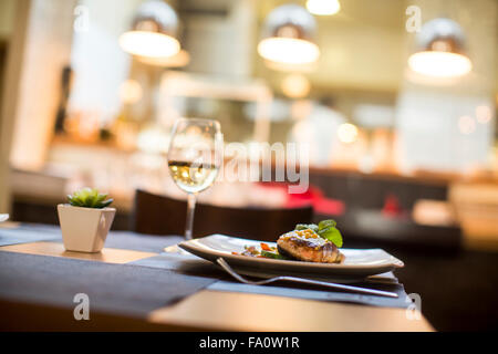 Grilled salmon with sauce and herbs served at restaurant Stock Photo