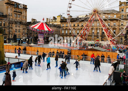 Glasgow, UK. 19th Dec, 2015. Once again, for another year, an outdoor ice rink and carnival funfair has been built in George Square, Glasgow, in the city centre. This is giving hours of fun and entertainment to those who are exhausted from Christmas shopping. The ice rink is proving to be a great attraction for all ages and abilities, even with the unseasonably warm weather and the ice surface melting. Credit:  Findlay/Alamy Live News Stock Photo