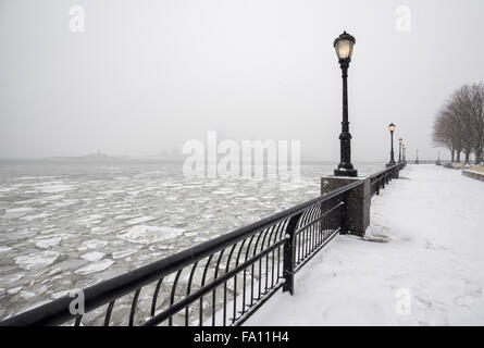 Frozen Hudson River from snowy Battery Park towards Jersey City in fog. A silent winter day in New York City Stock Photo
