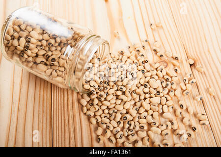 eye beans in jar on wooden table Stock Photo