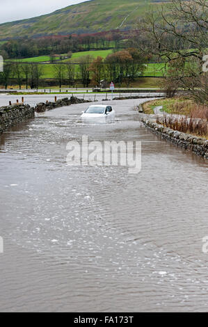 A car caught up in the flooding around Hawes, Wensleydale in North Yorkshire. The second time flooding has hit the are in the pa Stock Photo