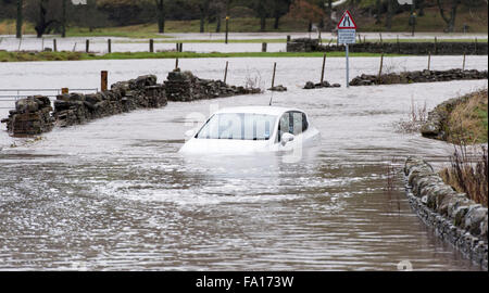 A car caught up in the flooding around Hawes, Wensleydale in North Yorkshire. The second time flooding has hit the are in the pa Stock Photo