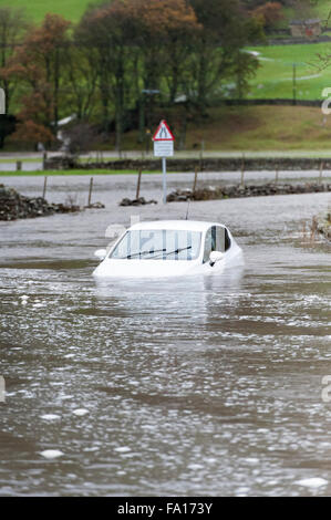 A car caught up in the flooding around Hawes, Wensleydale in North Yorkshire. The second time flooding has hit the are in the pa Stock Photo