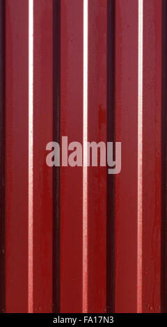 Diagonal pattern of metal profile. Fences from the galvanized iron painted by a polymeric covering. Stock Photo