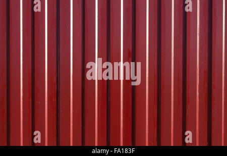 Diagonal pattern of metal profile. Fences from the galvanized iron painted by a polymeric covering. Stock Photo