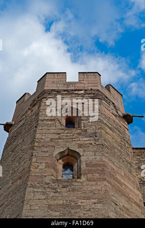Exterior view of an antique medieval English castle tower facade from below