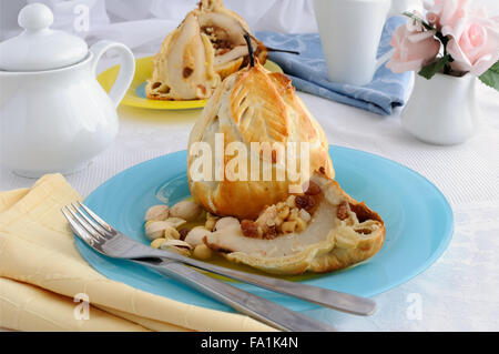 Baked pears stuffed with a mixture of nuts and raisins in the dough Stock Photo