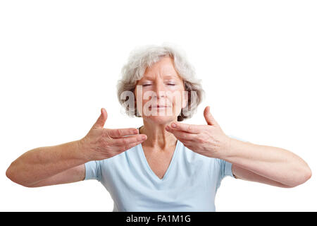 Relaxed senior woman doing some breathing exercises Stock Photo