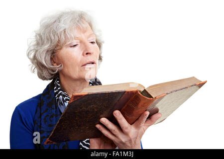 Elderly woman reading in an old book Stock Photo