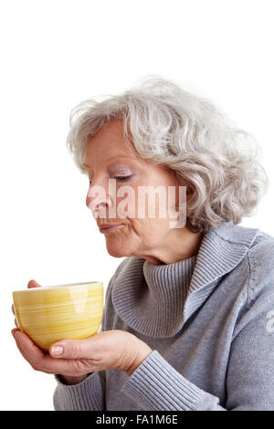 Senior woman drinking a cup of hot coffee Stock Photo