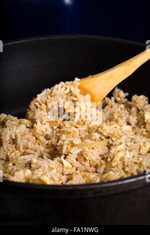 Fried rice with yolk and onion in frying pan Stock Photo