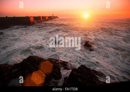 Pier in the Ocean, during amazing bloody sunset. Stock Photo