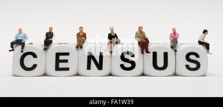 Miniture people sitting on the word Census Stock Photo