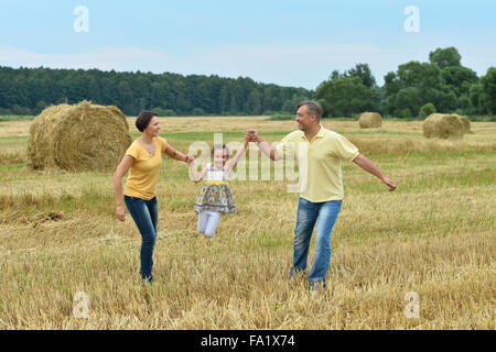 Family with  daughter at  field Stock Photo