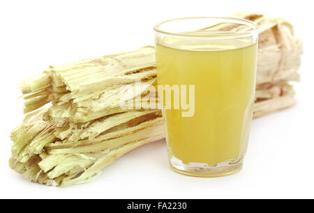 Sugarcane juice with bagasse over white background Stock Photo