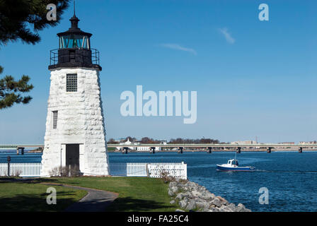 Lobster boat passes by Newport Harbor Lighthouse in Rhode Island. Lobstering is a major industry in this region, along with tourism. Stock Photo